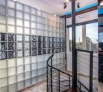 This artistic glass block wall design greets you upon entering the 3rd floor Penthouse Suite via a spiral stairway.